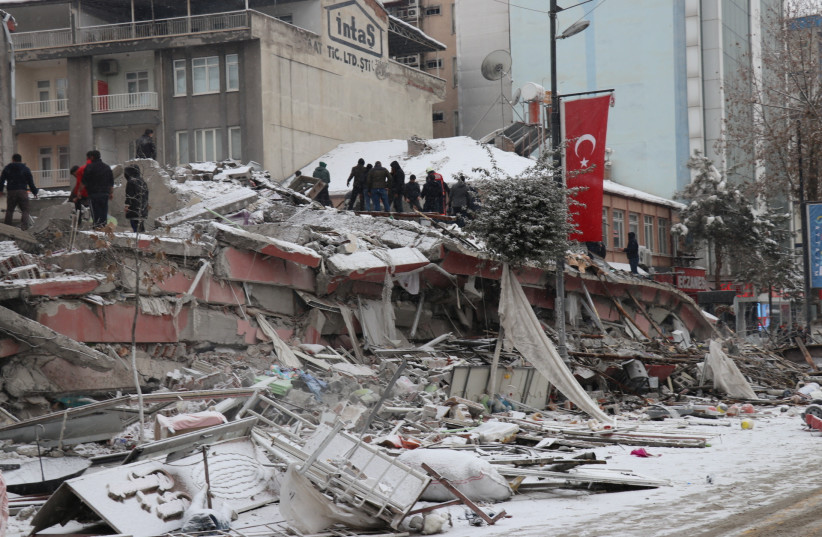 Rescuers carry out a person from a collapsed building after an earthquake in Malatya, Turkey February 6, 2023. (photo credit: Ihlas News Agency (IHA) via REUTERS)