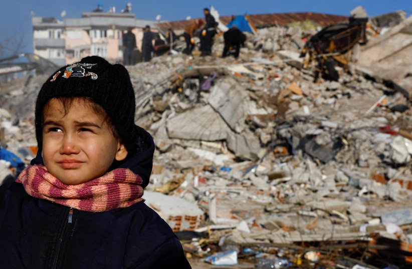  A child looks on in the aftermath of a deadly earthquake in Kahramanmaras, Turkey, February 8, 2023.  (credit: REUTERS/SUHAIB SALEM)