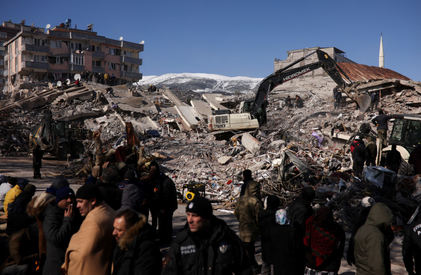  People work at the site of a collapsed building, in the aftermath of a deadly earthquake in Kahramanmaras, Turkey February 8, 2023. (photo credit: STOYAN NENOV/REUTERS)