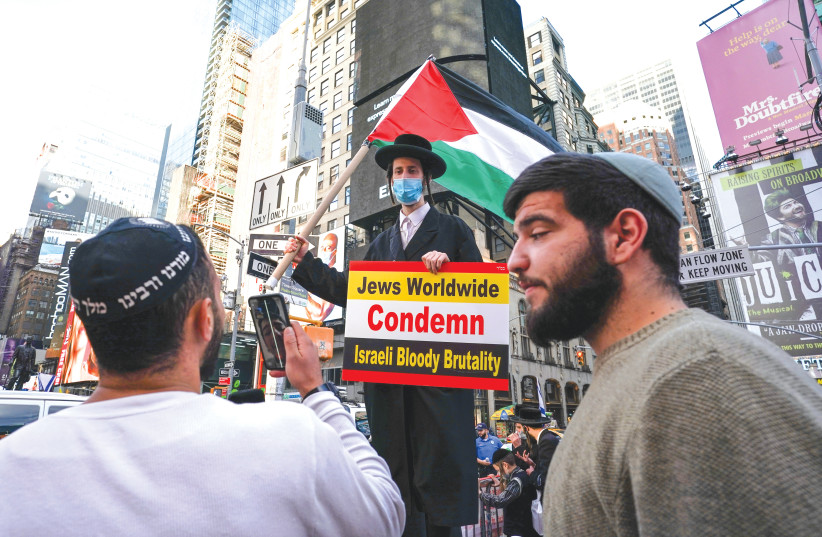  PRO-AND anti-Israel Jewish demonstrators face each other at a rally at New York’s Times Square in 2021. (photo credit: REUTERS/DAVID 'DEE' DELGADO)