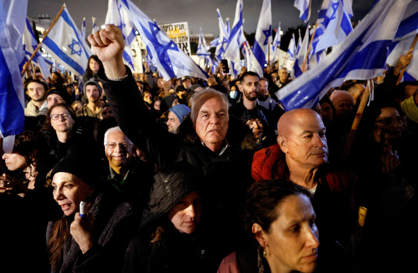 Israelis protest against Prime Minister Benjamin Netanyahu's new right-wing coalition and its proposed judicial reforms to reduce powers of the Supreme Court in a main square in Tel Aviv, Israel, January 14, 2023. (credit: REUTERS/AMIR COHEN/FILE PHOTO)