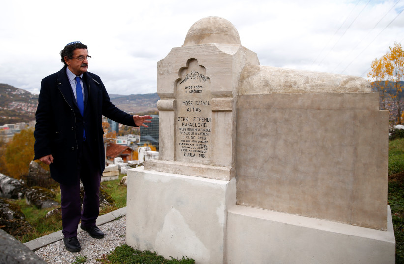 Eli Tauber stands near the resting place of a Jewish historian, whose real name was Mose Attias, known as Zeki Effendi Rafaelovic, at the Jewish cemetery in Sarajevo, Bosnia and Herzegovina, November 6, 2019. (credit: REUTERS/DADO RUVIC)