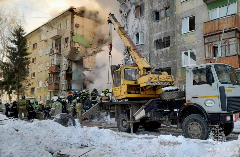  Rescuers remove the rubble of a five-floor residential building heavily damaged in a gas explosion in Novosibirsk, Russia February 9, 2023 (photo credit: Russian Emergencies Ministry/Handout via REUTERS)
