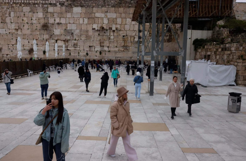 Women are seen walking across the Western Wall site in a photo taken February 9, 2023  (credit: MARC ISRAEL SELLEM/THE JERUSALEM POST)