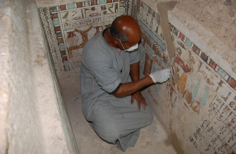  An Egyptian employee works at the 4,000-year-old tomb of Meru, the oldest site accessible to the public on Luxor's West Bank, home to some of its most spectacular Pharaonic monuments including the Valley of the Kings, after restoration by a Polish mission in Luxor and Egyptian archaeologists, by th (credit: The Egyptian Ministry of Antiquities/Handout)
