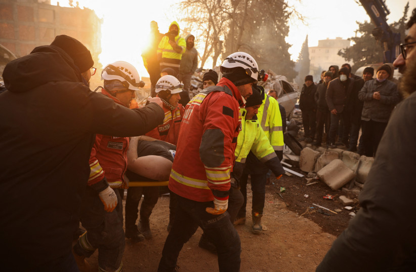  Rescuers carry 30-year-old survivor Omer Faruk Telbisoglu on a stretcher after he was rescued, in the aftermath of a deadly earthquake in Kahramanmaras, Turkey February 10, 2023.  (credit: REUTERS/STOYAN NENOV)