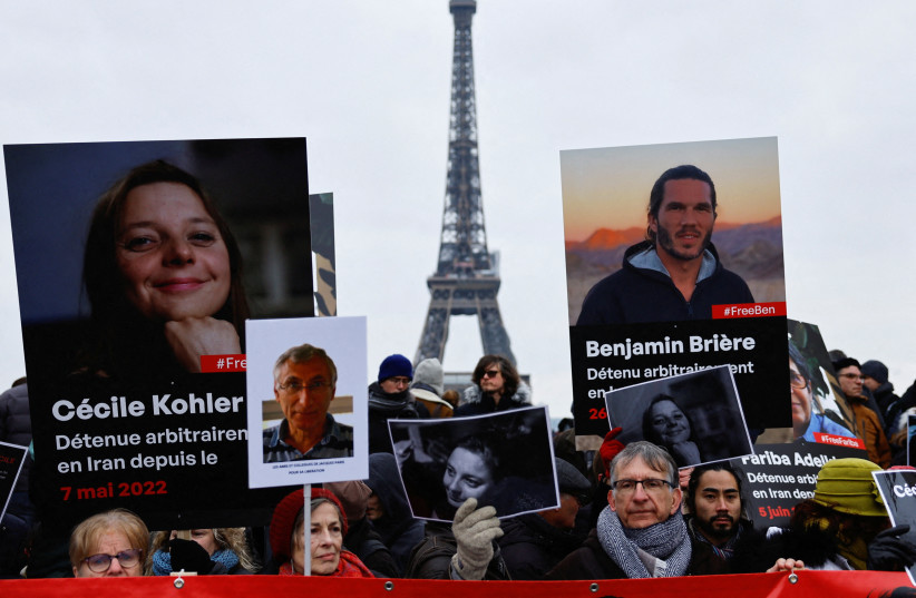 Supporters and relatives of French citizens detained in Iran, Cecile Kohler, Benjamin Briere, Jacques Paris and Fariba Adelkhah, gather in front of the Eiffel Tower, during a rally demanding their release, in Paris, France, January 28, 2023. (credit: REUTERS/CHRISTIAN HARTMANN/FILE PHOTO)