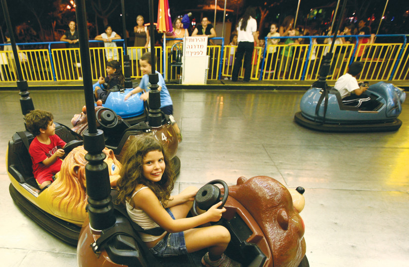  CHILDREN RIDE on bumper cars at Superland in Rishon Lezion. Is this the Israeli driving experience? (photo credit: NATI SHOHAT/FLASH90)