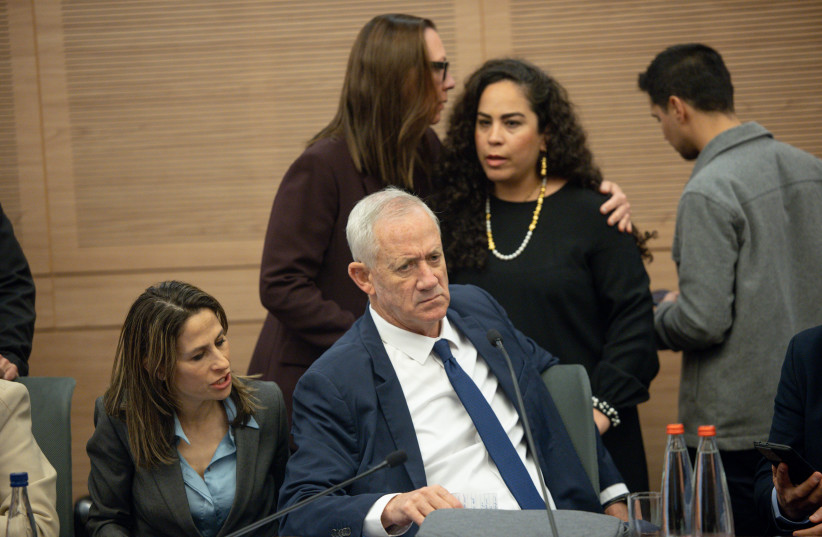  MK Benny Gantz is seen sitting at a chaotic session of the Knesset Law and Constitution Committee in Jerusalem during a debate on judicial reform, on February 13, 2023. (photo credit: YONATAN SINDEL/FLASH90)