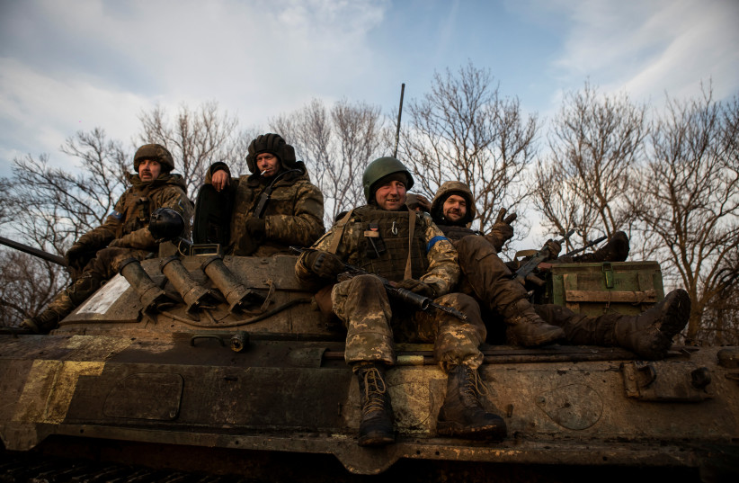  Ukrainian servicemen sit atop a BMP-2 infantry fighting vehicle on a road outside the frontline town of Bakhmut, amid Russia's attack on Ukraine, in Donetsk region, Ukraine February 11, 2023 (photo credit: REUTERS/Yevhenii Zavhorodnii)