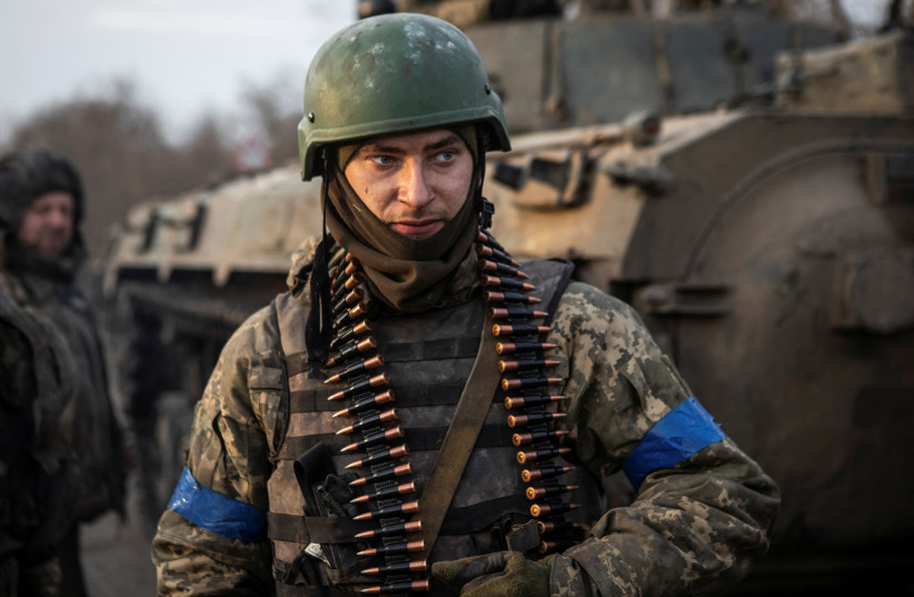  A Ukrainian serviceman stands on the road outside the frontline town of Bakhmut, amid Russia's attack on Ukraine, in Donetsk region, Ukraine February 11, 2023 (credit: REUTERS/Yevhenii Zavhorodnii)