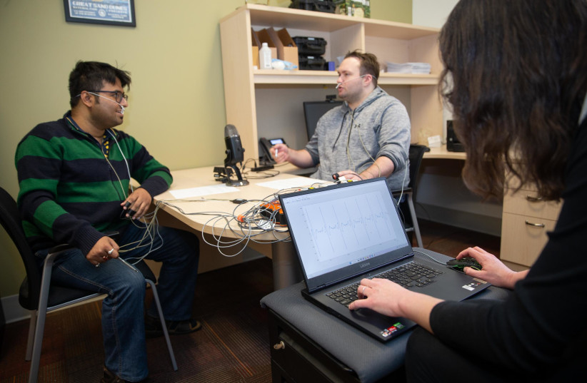  University of Cincinnati engineering students demonstrate how they taught a computer to distinguish types of conversations based only on physiological cues. (photo credit: ANDREW HIGLEY)