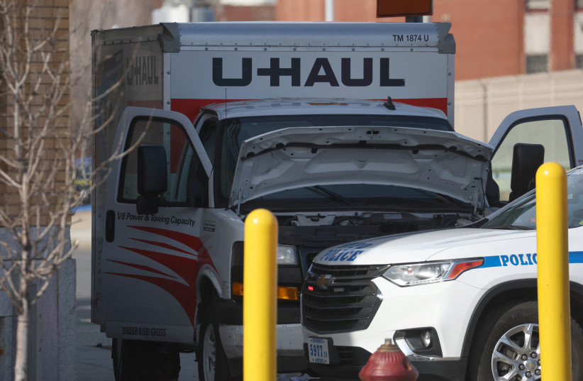  A New York Police Department vehicle blocks a U-Haul rental vehicle, where according to media reports, a man struck multiple people and the NYPD took the driver into custody, near the Battery tunnel in the Brooklyn borough of New York City, US, February 13, 2023.  (photo credit: REUTERS/SHANNON STAPLETON)