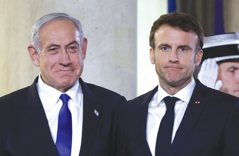  FRENCH PRESIDENT Emmanuel Macron welcomes Prime Minister Benjamin Netanyahu at the Elysee Palace, earlier this month. (photo credit: BENOIT TESSIER/REUTERS)