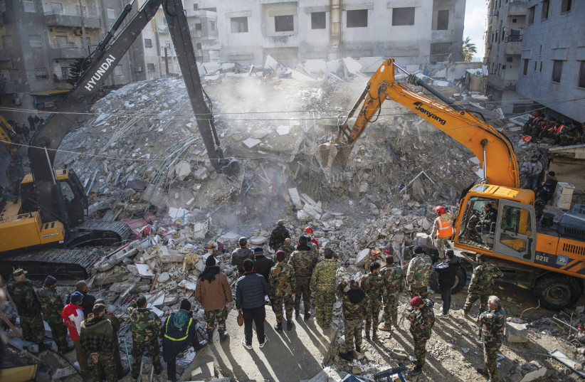  RESCUE WORKERS search for earthquake survivors among the rubble in Latakia Province, Syria, Feb. 7. (photo credit: AFP VIA GETTY IMAGES)