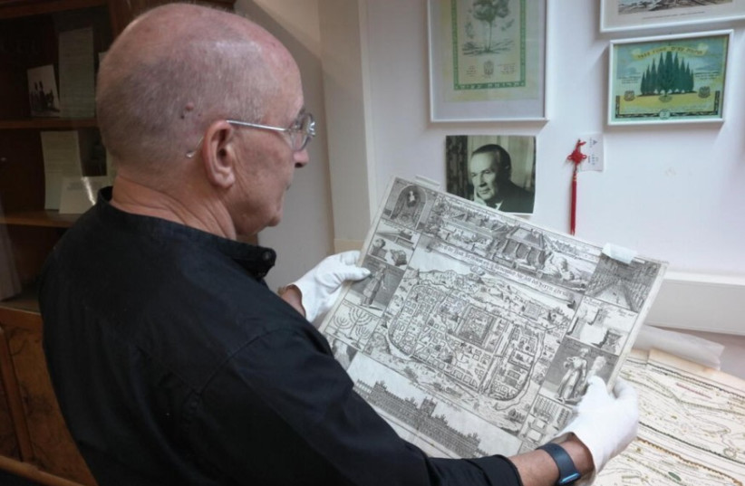 A researcher holds a drawing from the Umansky Collection (credit: UNIVERSITY OF HAIFA)