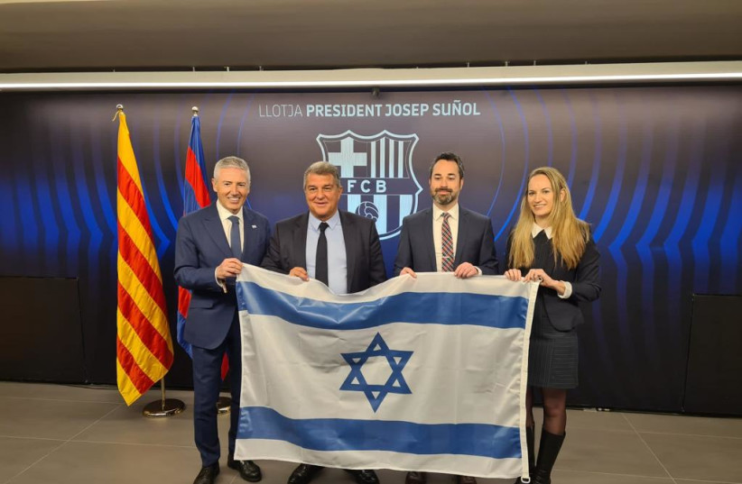 Israeli diplomats presented FC Barcelona's president Laporta with an Israeli flag on February 16, 2023, recognizing FC Barcelona's years of support for and friendship with Israel.  (photo credit: ISRAELI EMBASSY IN SPAIN)