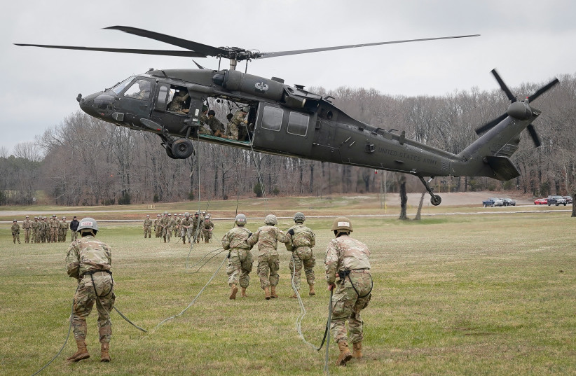 Soldiers attending the United States Army Air Assault School prepare to rappel from a UH-60 Blackhawk helicopter at Fort Campbell, Kentucky, US, Feb 13, 2020. (credit: REUTERS/BRYAN WOOLSTON)