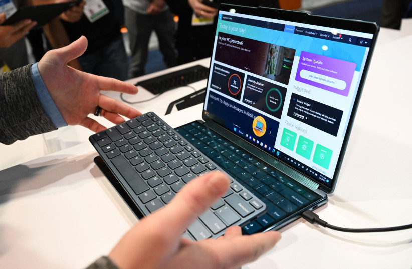  The new Lenovo dual-screen Yoga Book 9i laptop is demonstrated with different screen and keyboard modes at the Microsoft Inc. booth during the Consumer Electronics Show (CES) in Las Vegas, Nevada on January 6, 2023.  (credit: PATRICK T. FALLON/AFP via Getty Images)
