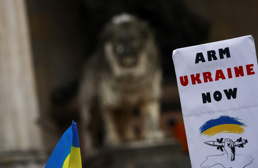  A placard is seen at a pro-Ukrainian demonstration, during the Munich Security Conference (MSC) in Munich, Germany February 18, 2023.  (credit: REUTERS/KAI PFAFFENBACH)