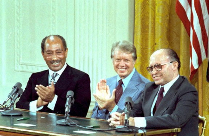 US President Jimmy Carter, Egyptian President Anwar Sadat and Israeli Prime Minister Menachem Begin during the signing of the Camp David Accords in the East Room of the White House in Washington, DC, September 17, 1978. (credit: COURTESY JIMMY CARTER LIBRARY/NATIONAL ARCHIVES/HANDOUT VIA REUTERS/FILE PHOTO)