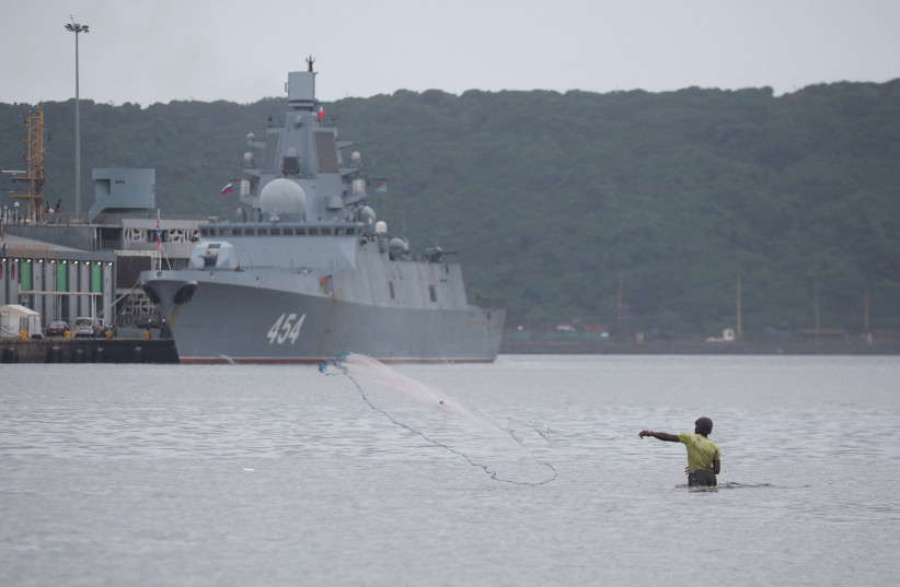  A man fishes with a cast net in the harbor where the Russian frigate Admiral Gorshkov is docked en route to scheduled naval exercises with the South African and Chinese navies in Durban, South Africa, February 17, 2023.  (photo credit: ROGAN WARD / REUTERS)