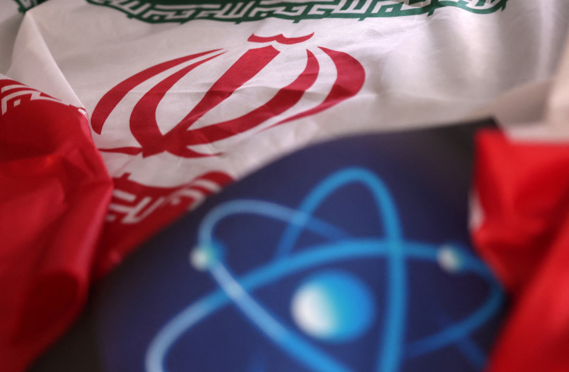  Atomic symbol and Iranian flag are seen in this illustration taken September 8, 2022. (photo credit: REUTERS/DADO RUVIC/ILLUSTRATION)