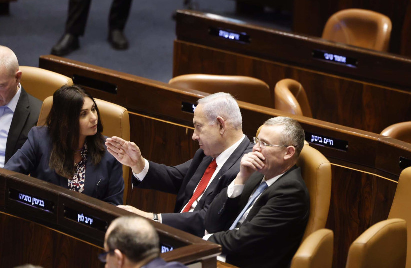  Israeli Prime Minister Benjamin Netanyahu (C) is seen sitting next to Transportation Minister Miri Regev and Justice Minister Yariv Levin in the Knesset plenum ahead of a vote on judicial reform, in Jerusalem, on February 20, 2023. (photo credit: MARC ISRAEL SELLEM/THE JERUSALEM POST)