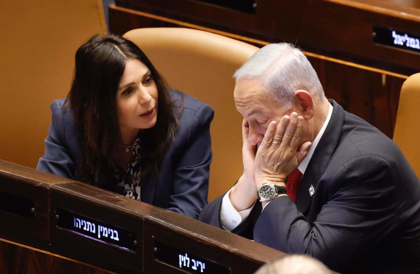  Israeli Prime Minister Benjamin Netanyahu is seen sitting with his face in his hands next to Transportation Minister Miri Regev in the Knesset plenum in Jerusalem, on February 20, 2023. (photo credit: MARC ISRAEL SELLEM/THE JERUSALEM POST)