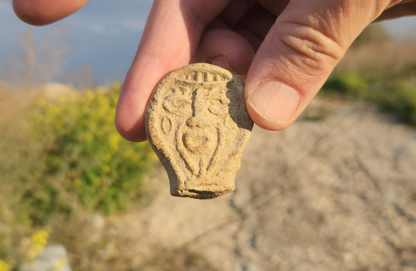 The candle handle that was discovered in the Tzur Yaakov hills, the Antiquities Authority. (photo credit: LAVI FAMILY VIA ISRAEL ANTIQUITIES AUTHORITY)