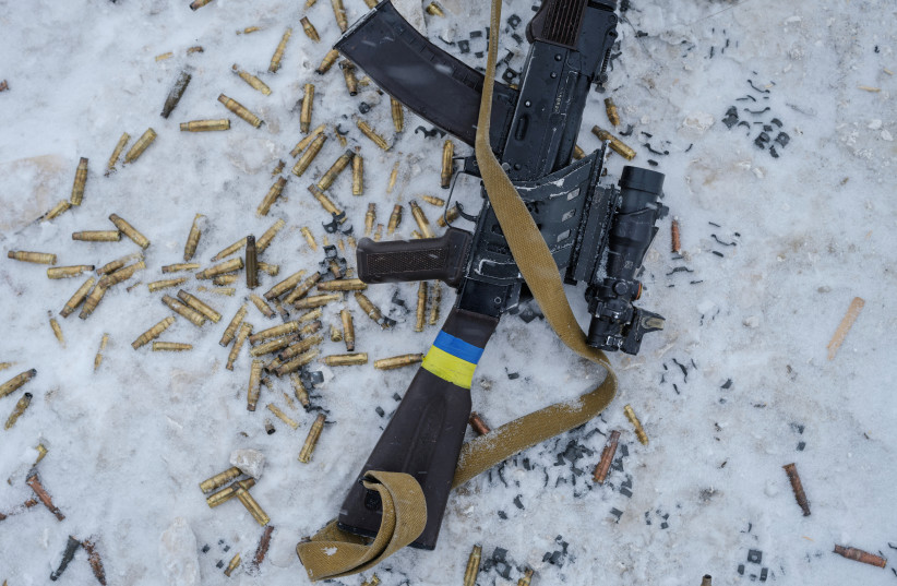  A rifle and empty shells are seen at a shooting range, amid Russia's attack on Ukraine, in Siversk, Donetsk region, Ukraine, February 18, 2023. (photo credit: REUTERS/MARKO DJURICA)