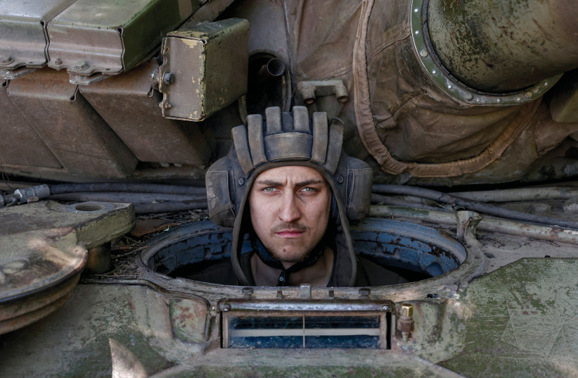  A Ukrainian serviceman looks on from inside a tank in Donetsk, as Russia waged war against Ukraine, on June 11, 2022. (photo credit: STRINGER/ REUTERS)