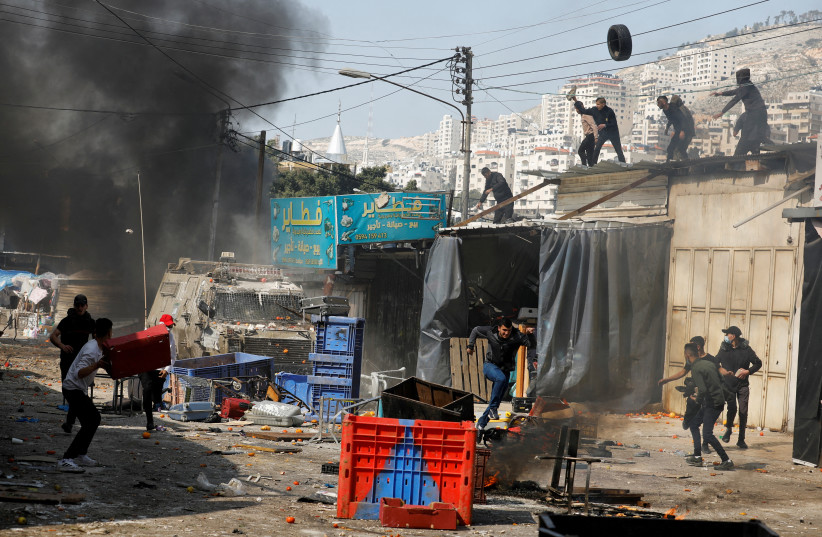  Palestinians clash with Israeli forces during a raid in Nablus in the West bank, February 22, 2023 (credit: REUTERS/RANEEN SAWAFTA)