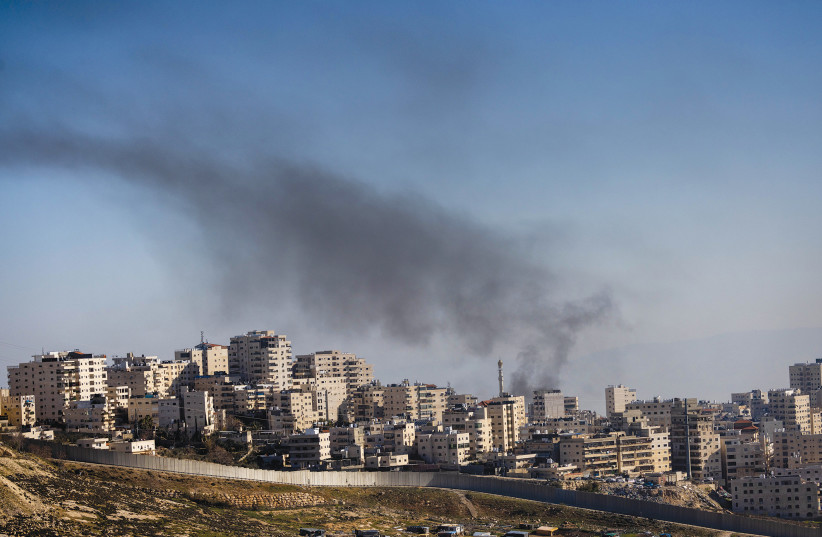 SMOKE RISES from the Shuafat refugee camp on Sunday. (photo credit: YONATAN SINDEL/FLASH90)