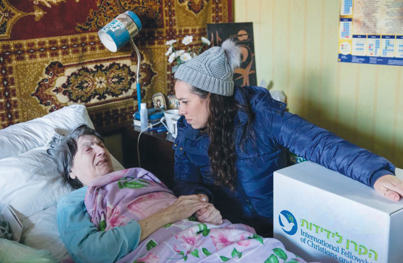  THE WRITER visits an elderly member of the Jewish community in Kyiv, bringing supplies to help with the harsh winter. (photo credit: SVETLANA VOIT)