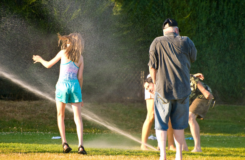  During heatwaves, people find any way to cool themselves down. (photo credit: FLICKR)