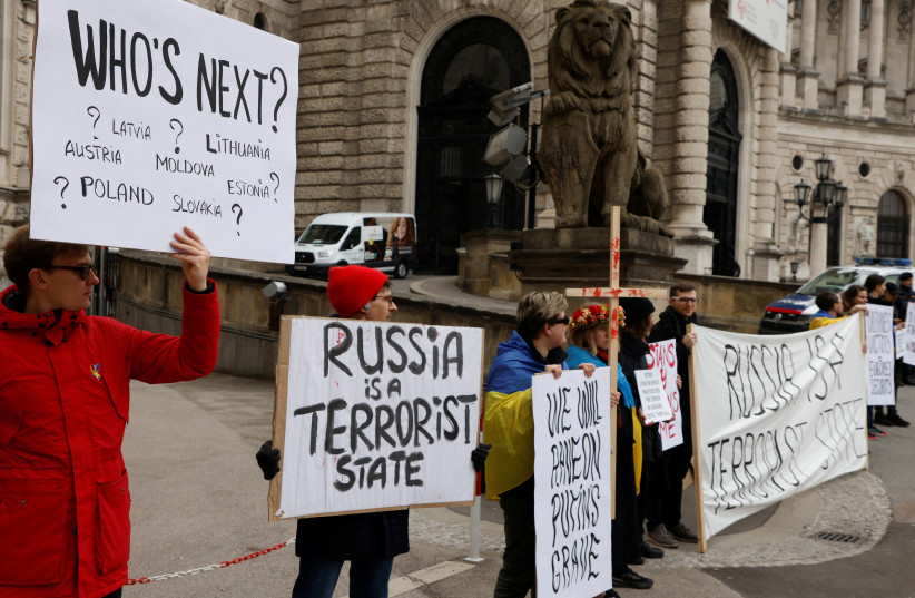  Protestors stand outside Hofburg Palace as a Parliamentary Assembly of the Organization for Security and Cooperation in Europe (OSCE) takes place in Vienna, Austria, February 23, 2023. (photo credit: REUTERS/LEONHARD FOEGER)