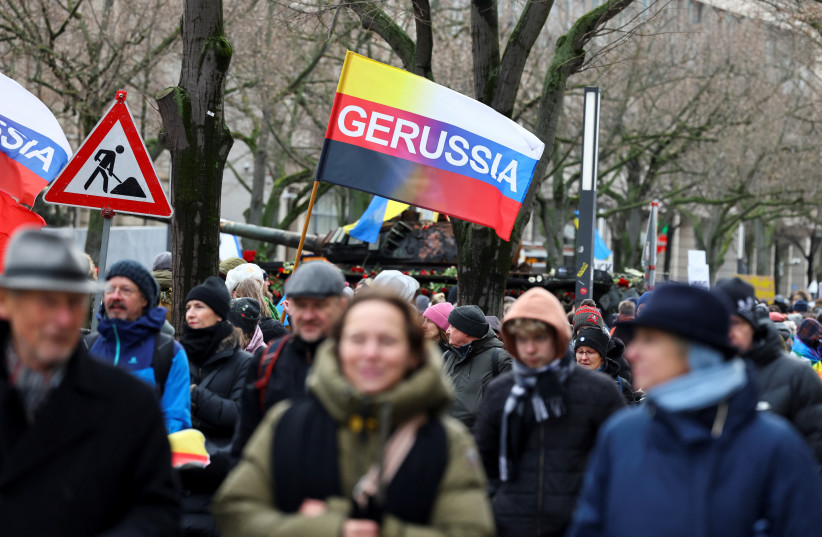  People take part in a protest against the delivery of weapons to Ukraine and in support of peace negotiations between Russia and Ukraine, amid Russia's invasion of Ukraine, in Berlin, Germany February 25, 2023 (photo credit: REUTERS/CHRISTIAN MANG)