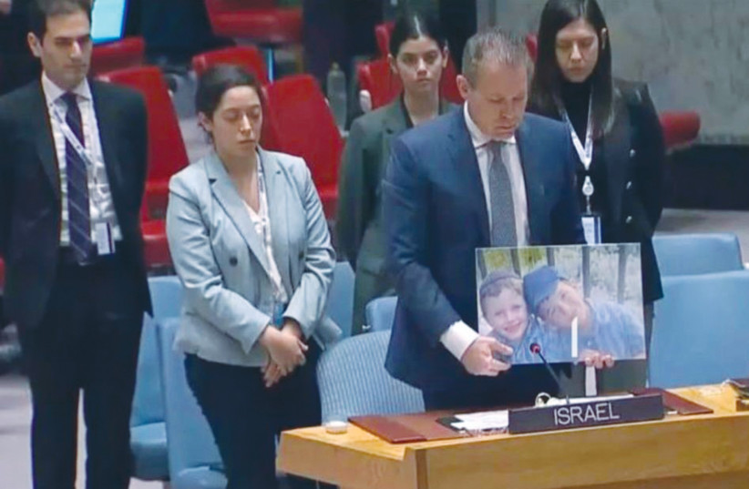  SPEAKING AT the UN Security Council last week, Israel’s UN Ambassador Gilad Erdan presents a photo of terror victims Yaakov and Asher Paley and dedicates a moment of silence in memory of all 11 people killed in recent Palestinian attacks. (photo credit: ISRAEL IN UN)