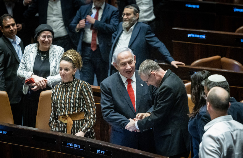  Israeli Prime Minister Benjamin Netanyahu, Justice Minister Yariv Levin and coalition members celebrate after a vote on the government's judicial overhaul plans in the assembly hall of the Knesset, the Israeli parliament in Jerusalem, on February 21, 2023. (credit: YONATAN SINDEL/FLASH90)