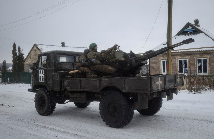  Ukrainian servicemen ride on a military vehicle with a ZU-23-2 anti-aircraft cannon, amid Russia's attack on Ukraine, in the front line city of Vuhledar, Ukraine February 18, 2023. (photo credit: Yevhen Titov/Reuters)