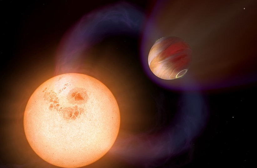  A gas giant is seen orbiting a red dwarf star in this artistic illustration. (photo credit: Wikimedia Commons)