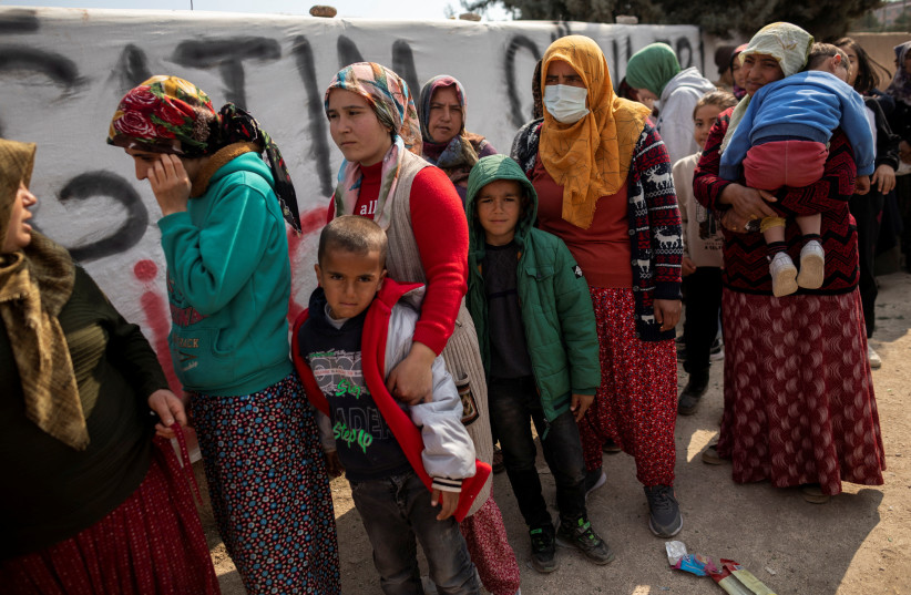 People affected by the deadly earthquake queue for aid in Hatay, Turkey, February 24, 2023. (credit: REUTERS/ELOISA LOPEZ)