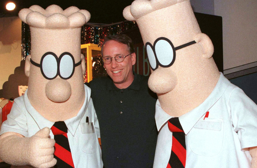  Scott Adams, the creator of "Dilbert", the cartoon character that lampoons the absurdities of corporate life, poses with two "Dilbert" characters at a party January 8, 1999 in Pasadena, Calif. (photo credit: REUTERS)