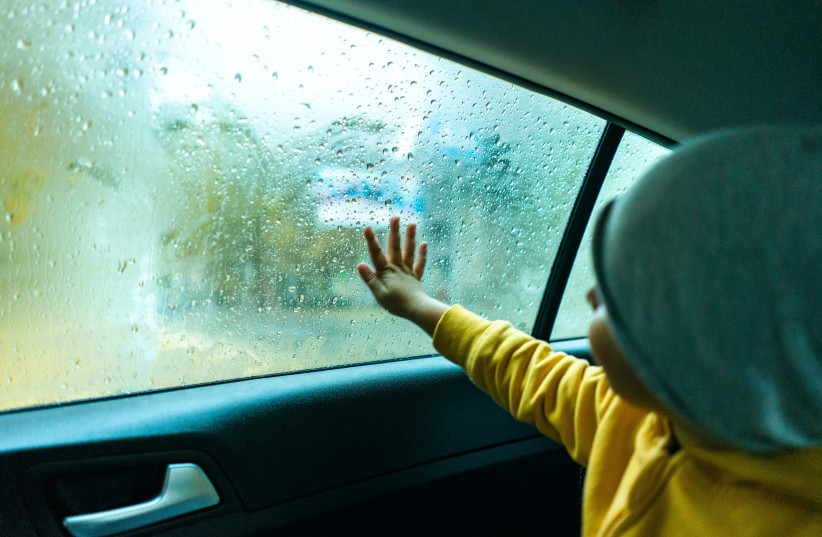  A child sits inside on a rainy day (illustrative) (credit: PEXELS)