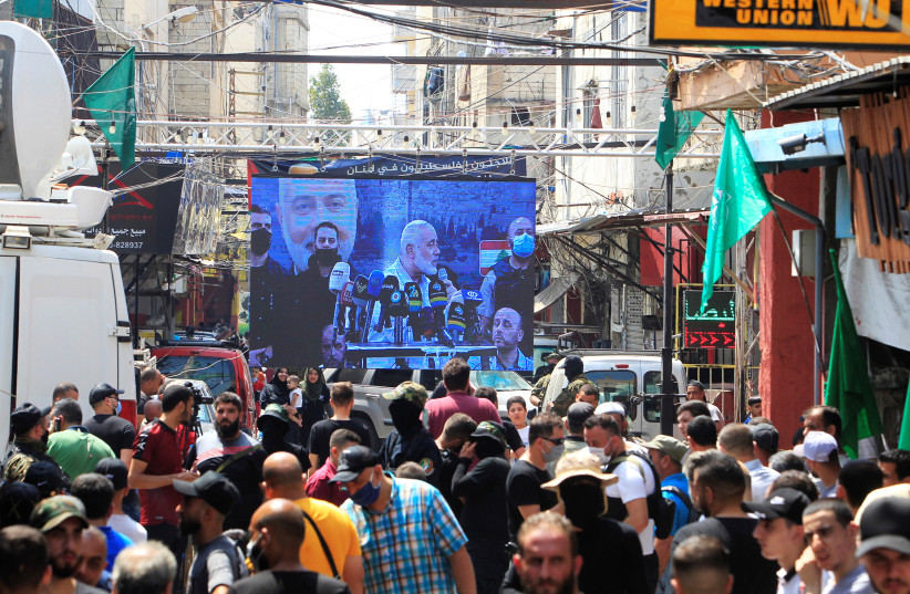  Palestinian group Hamas' top leader, Ismail Haniyeh, is seen projected on a screen as he speaks during his visit at Ain el Hilweh Palestinian refugee camp in Sidon, Lebanon September 6, 2020.  (credit: REUTERS/AZIZ TAHER)