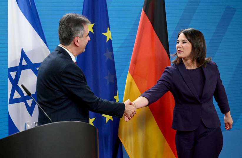 German Foreign Minister Annalena Baerbock and Israeli Foreign Minister Eli Cohen shake hands as they speak to reporters in Berlin, Germany, February 28, 2023 (photo credit: REUTERS/ANNEGRET HILSE)