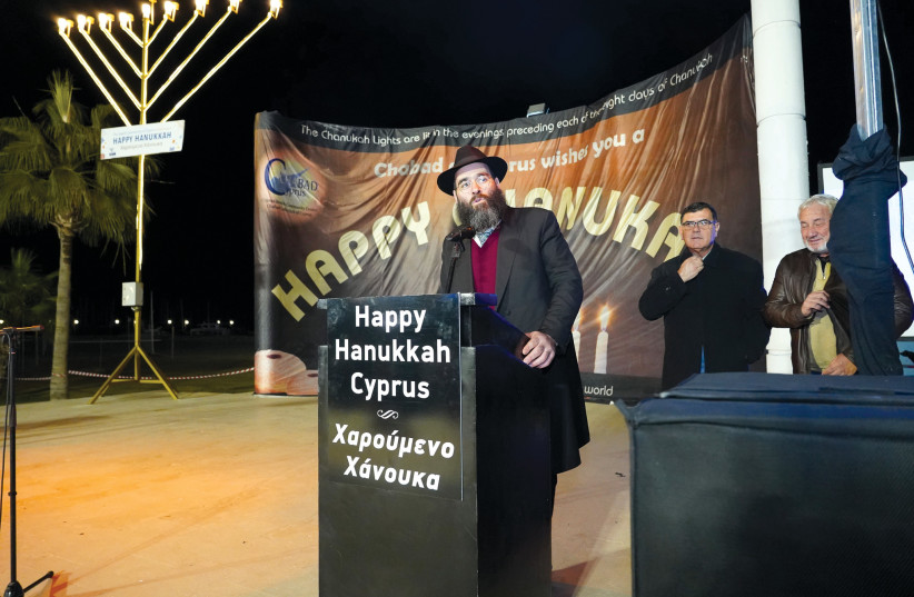  RABBI ARIE ZEEV RASKIN speaks at a Hanukkah event: Hundreds attend public menorah lightings across Cyprus. (credit: Chabad of Cyprus)