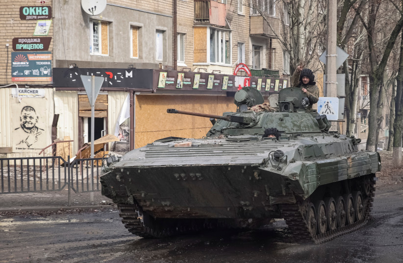  Ukrainian service members ride a BMP-2 infantry fighting vehicle an empty street, as Russia's attack on Ukraine continues, in the frontline city of Bakhmut, Ukraine February 27, 2023. (photo credit: REUTERS/YEVHEN TITOV)