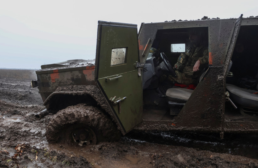  A Ukrainian service member sits inside an armoured vehicle stuck near the frontline town of Bakhmut, amid Russia's attack on Ukraine, in Donetsk region, Ukraine February 25, 2023. (photo credit: REUTERS/YAN DOBRONOSOV)
